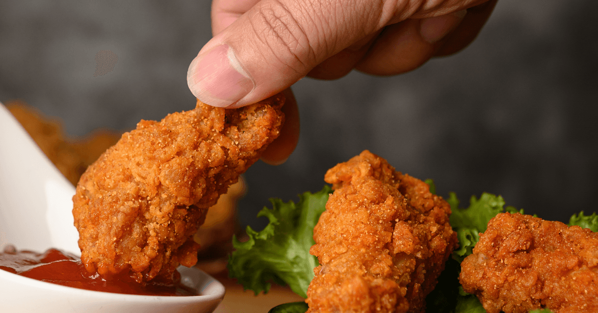 Golden-brown fried food with a crispy texture on a white plate, showcasing the perfect crunch.