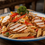 A plate of creamy Cajun chicken pasta garnished with parsley, featuring grilled chicken slices and bell peppers.