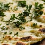 A close-up view of a golden-brown cottage cheese flatbread with a light char and sprinkled with fresh herbs.