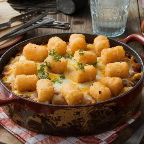 Cowboy casserole recipe: easy, cheesy, and delicious with crispy tater tots and gooey cheese.